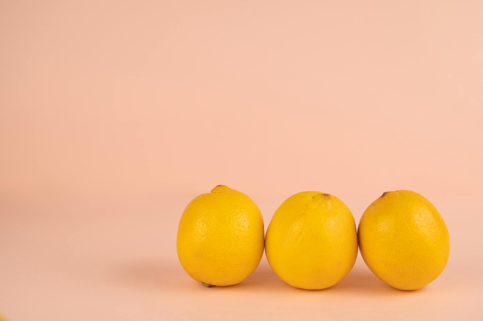 Bright ripe lemons arranged on a pastel background, symbolizing fresh beginnings and renewal