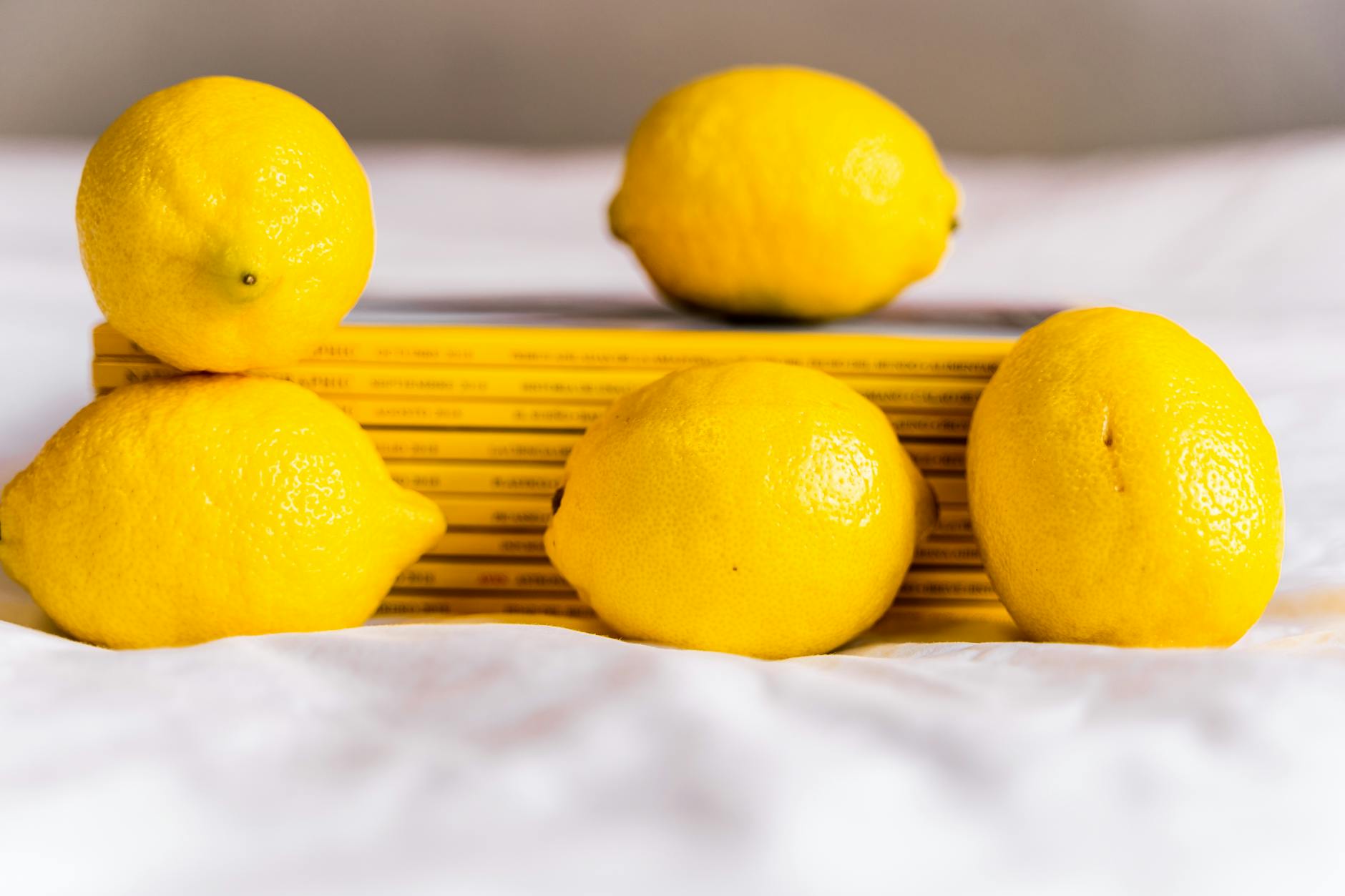 Bright yellow lemons arranged on a yellow background, symbolizing lemon vibrators